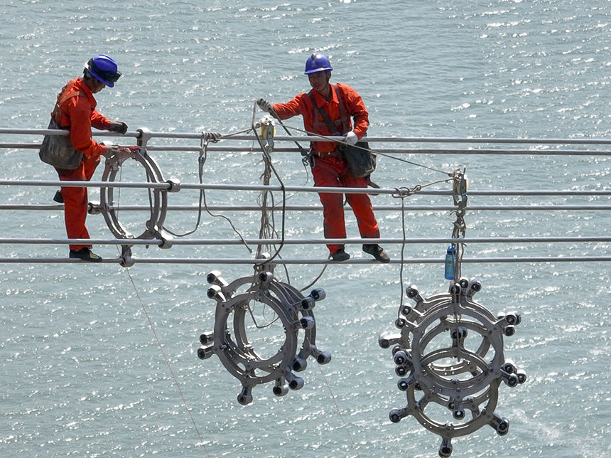 國網湖北電力員工在白浙線跨越長江線路上安裝間隔棒。雷勇攝