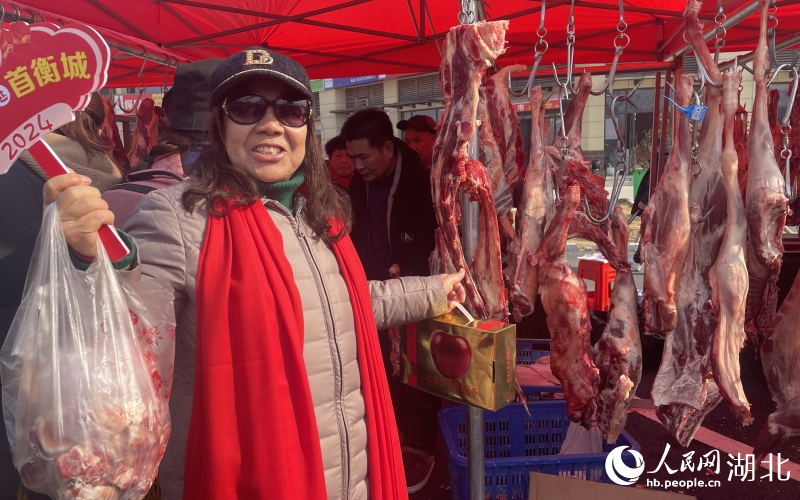 孝感市孝南區(qū)居民丁鳳華大媽在采購牛羊鮮肉、車厘子等年貨物資。人民網(wǎng)記者 周恬攝