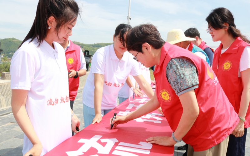 京堰兩地志愿者在“文明河流共建倡議”上集體簽名。